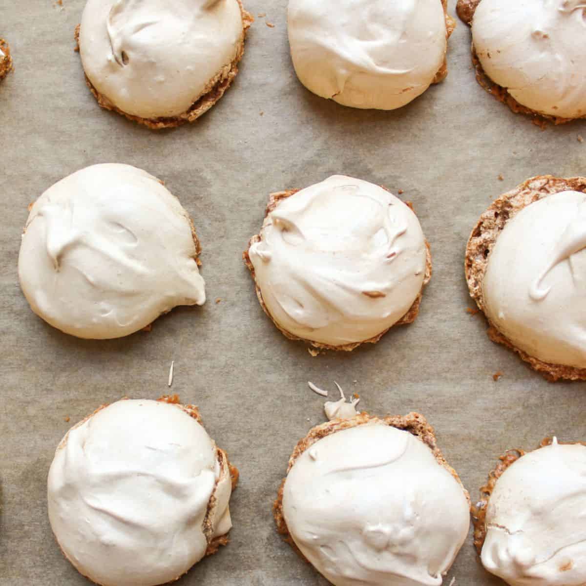 Light and crispy chocolate meringue cookies arranged on a baking pan lined with parchment paper.