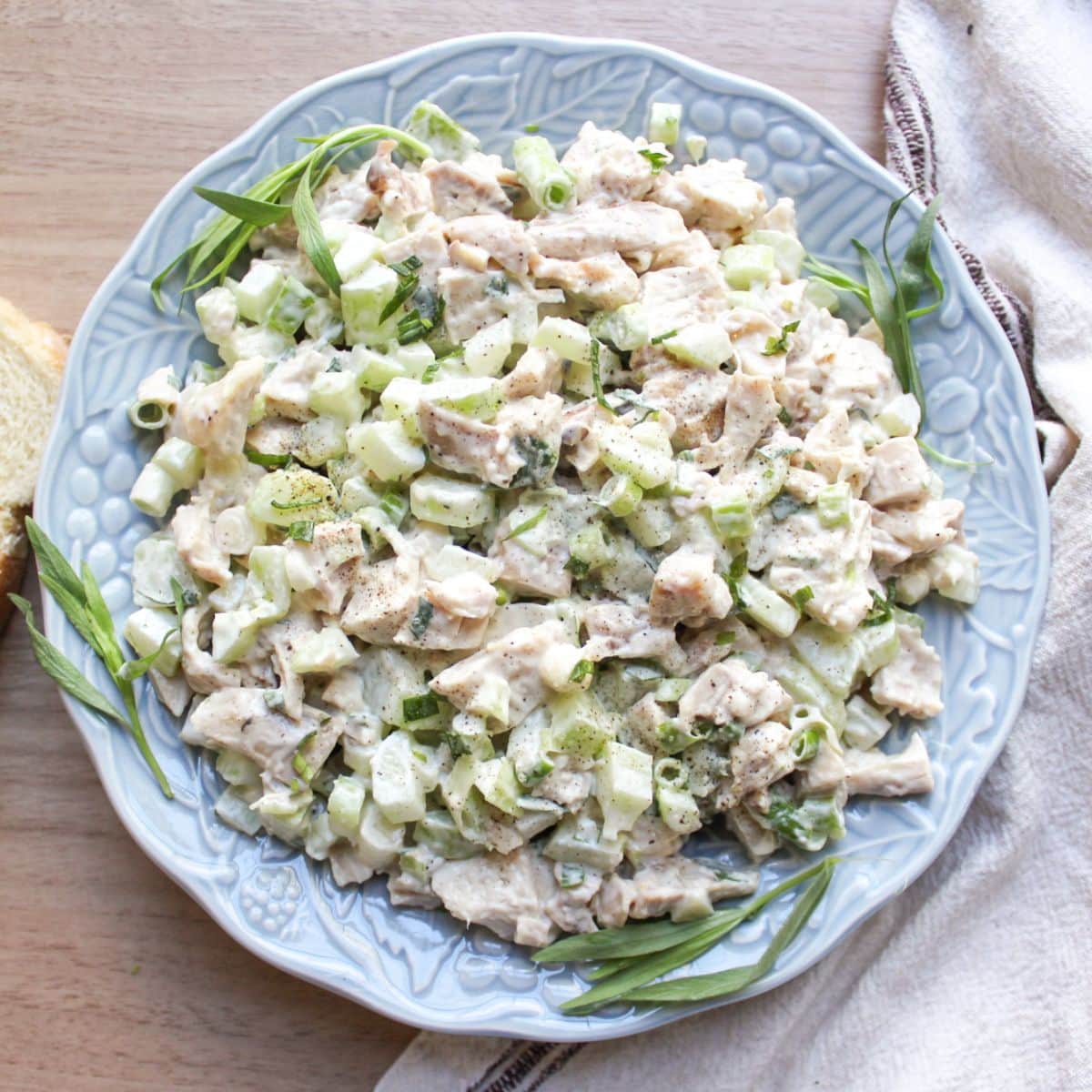 Classic chicken salad recipe made with tender chicken, crisp celery, and creamy mayo dressing, served in a blue bowl.