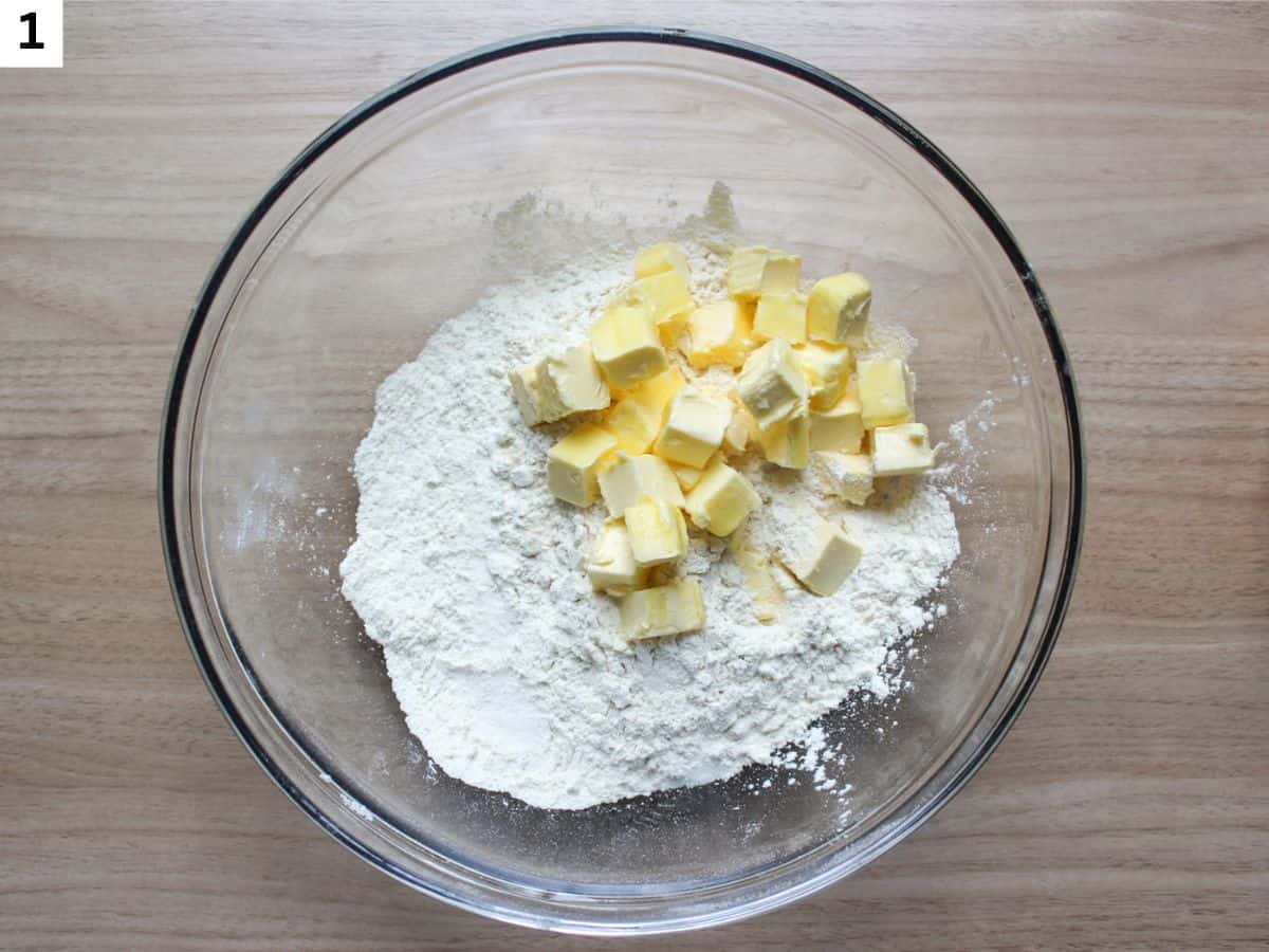 Adding cubed cold butter to the dry ingredients.