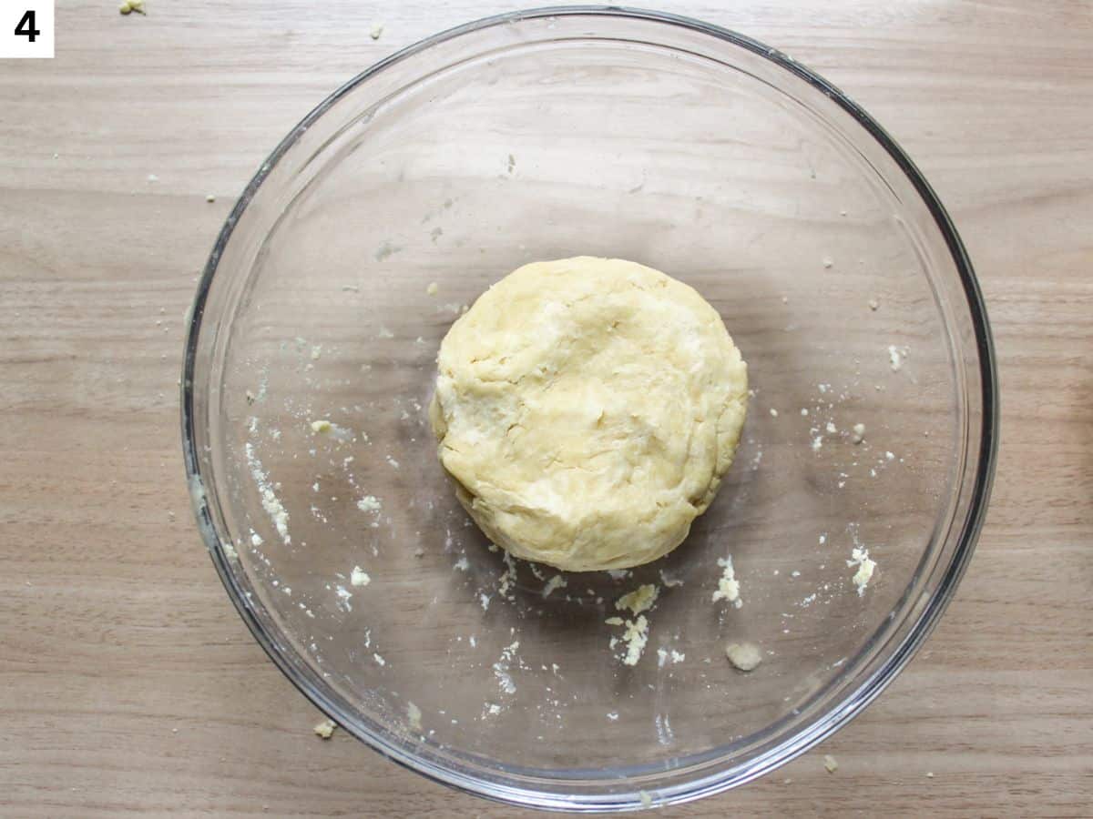 The tart dough formed into the disk in a bowl. 