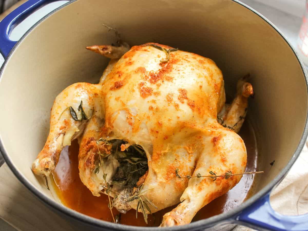Roasted whole chicken with lemon, butter and herbs, in the large dutch oven pot.