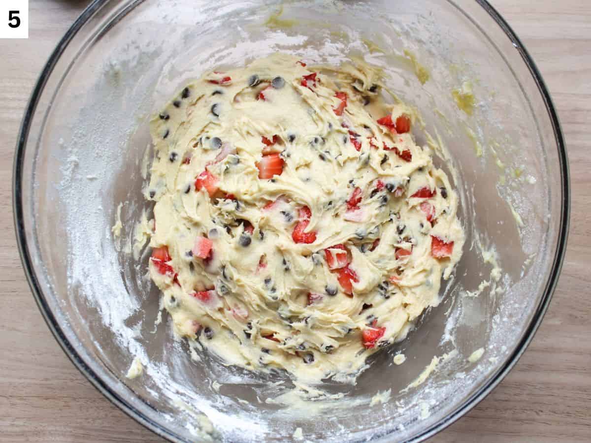 Strawberry chocolate chip cookie dough chilled in a glass bowl.