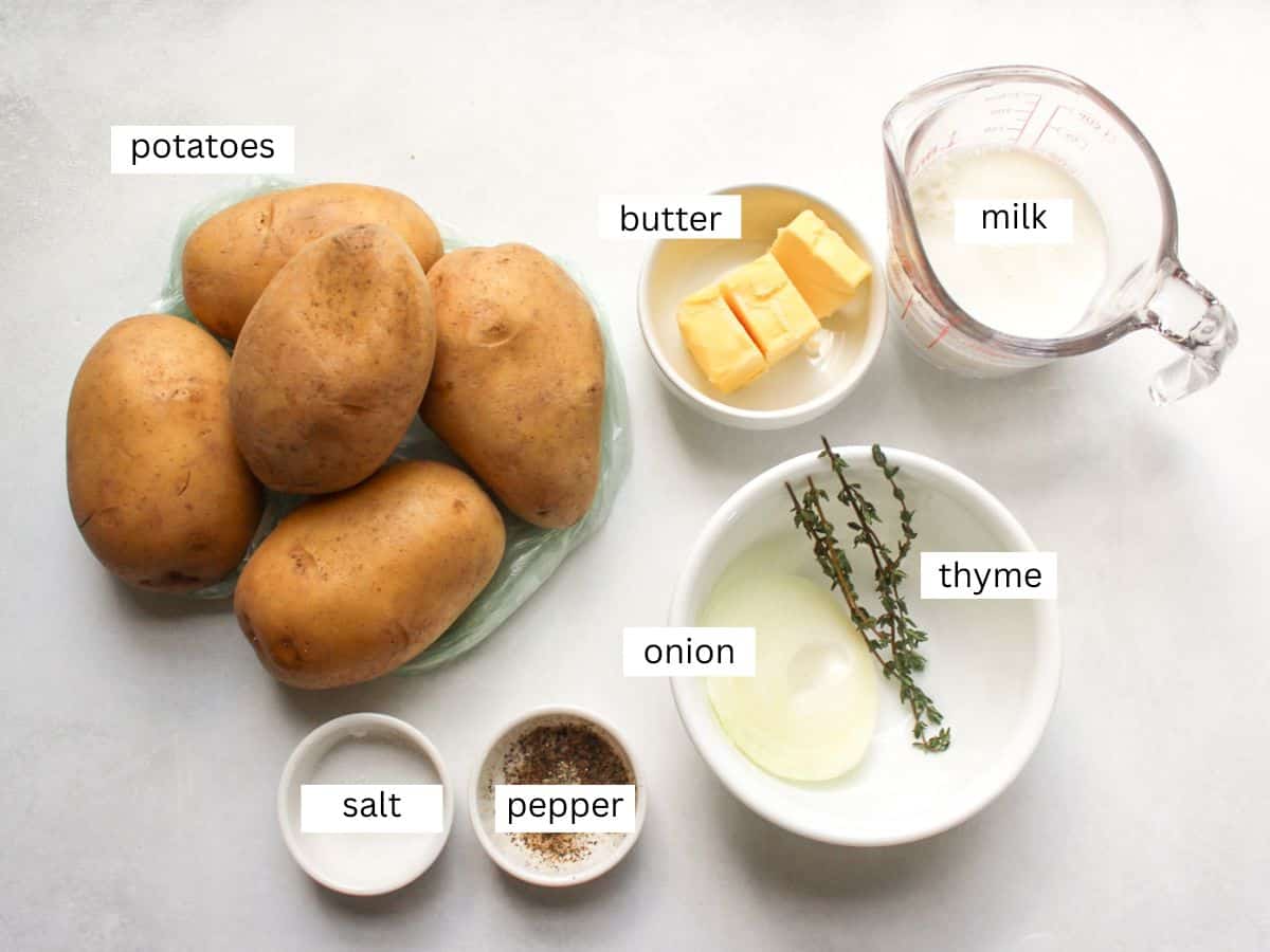 Recipe ingredients for classic mashed potatoes, including Yukon potatoes, milk, butter, onion, thyme, salt and pepper.