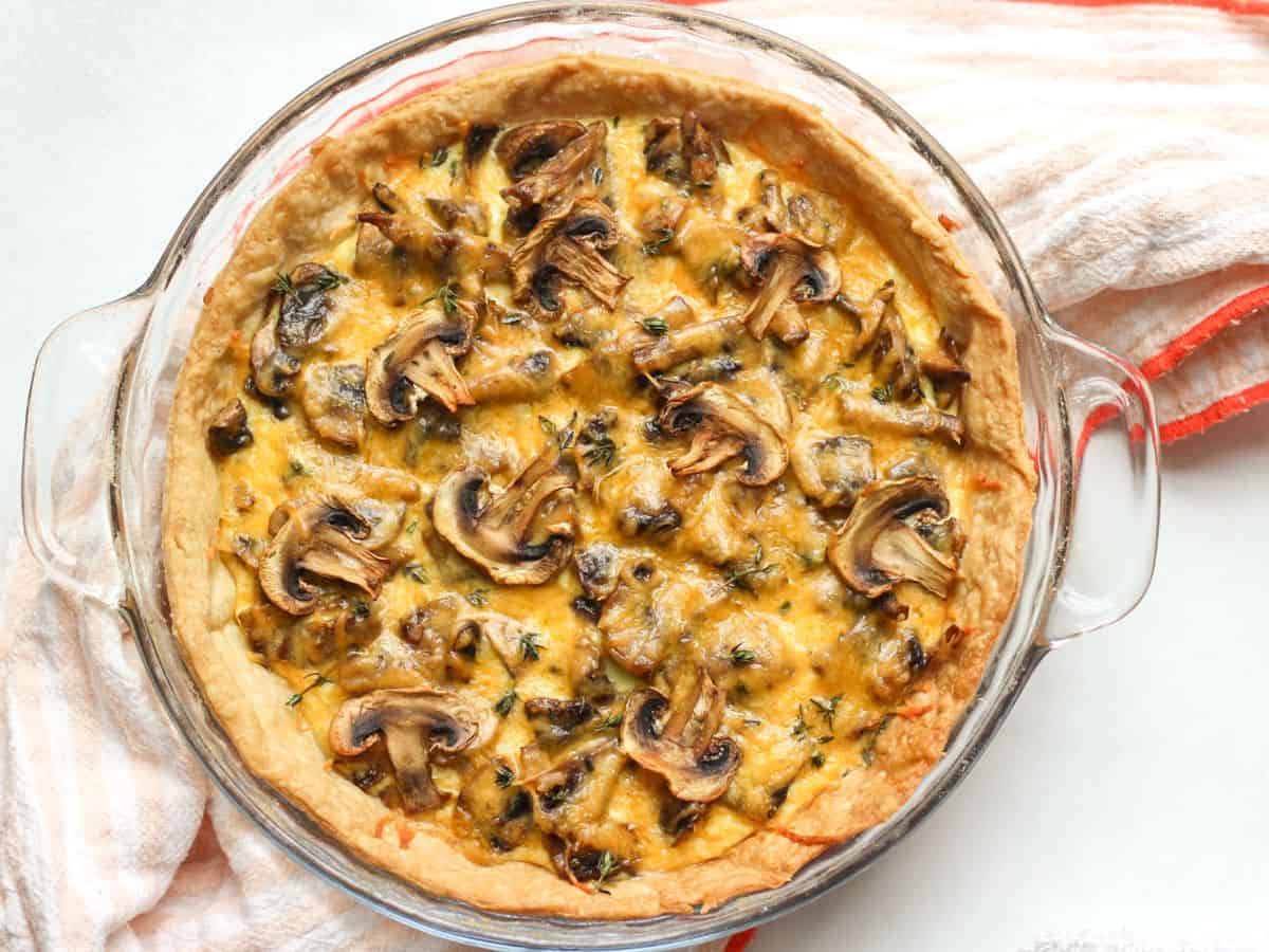 Round mushroom tart with flaky homemade tart crust, sauteed mushrooms, and melted cheese.