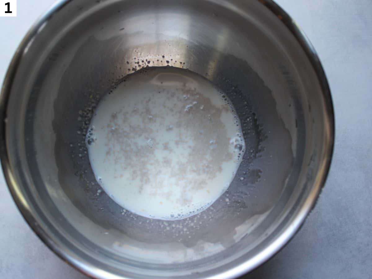 Yeast added to the warm milk in a large bowl.
