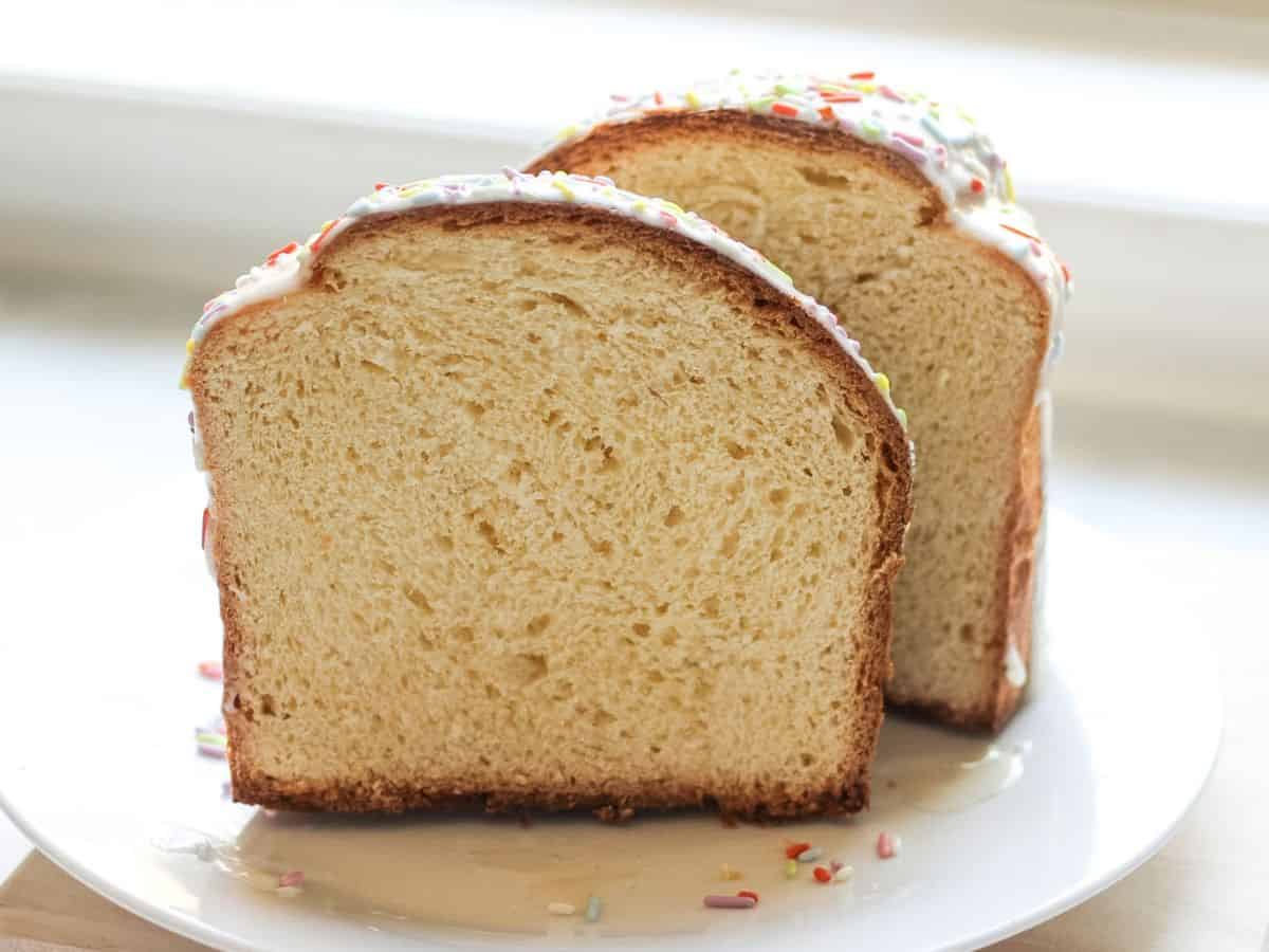 Paska bread sliced in half, showing the soft and light crumb inside.