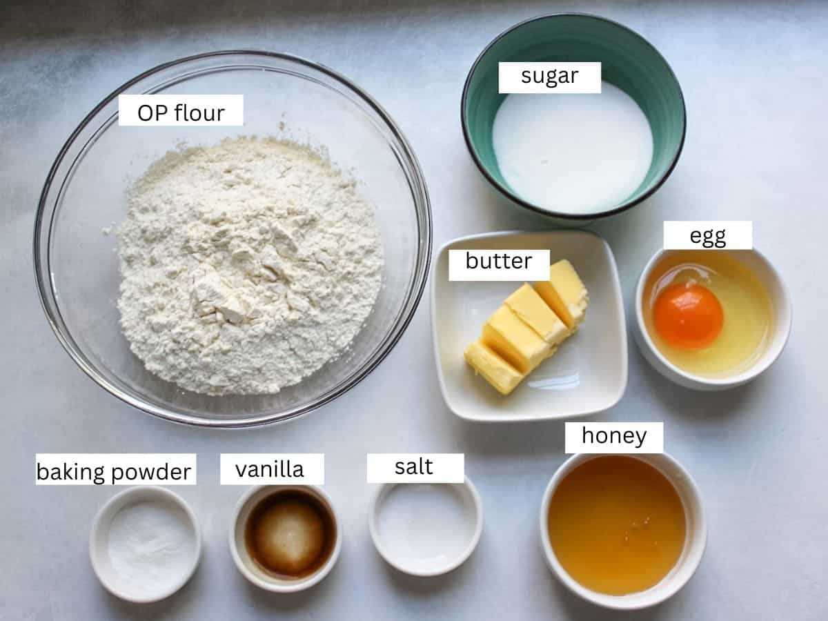 Ingredients for making honey cooking including flour, honey, egg, sugar, butter, vanilla extract, baking powder, salt. 