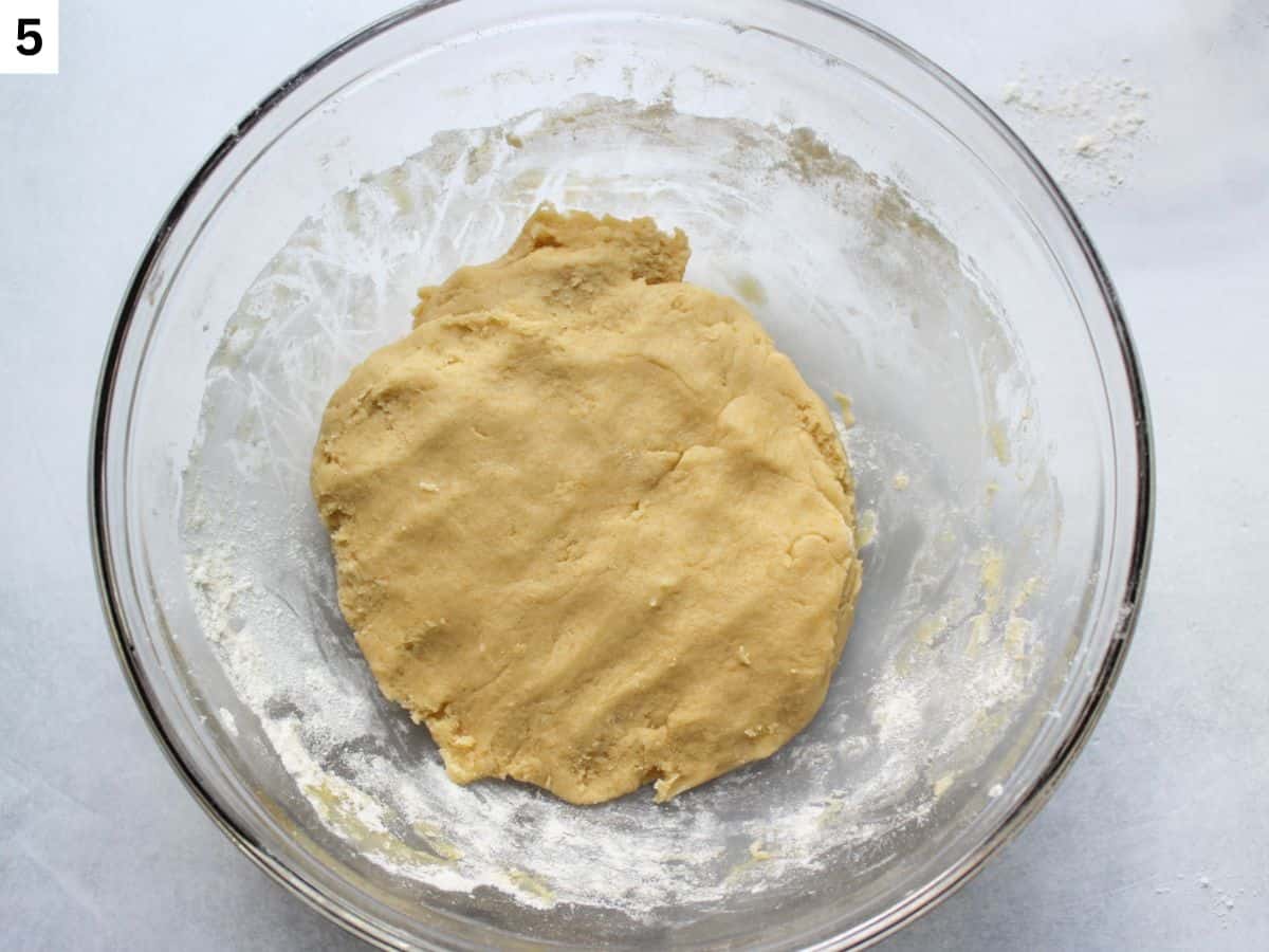 Soft honey cookie dough in a glass bowl.