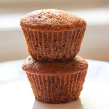 Honey muffins stacked on a plate, golden-brown outside, soft inside.