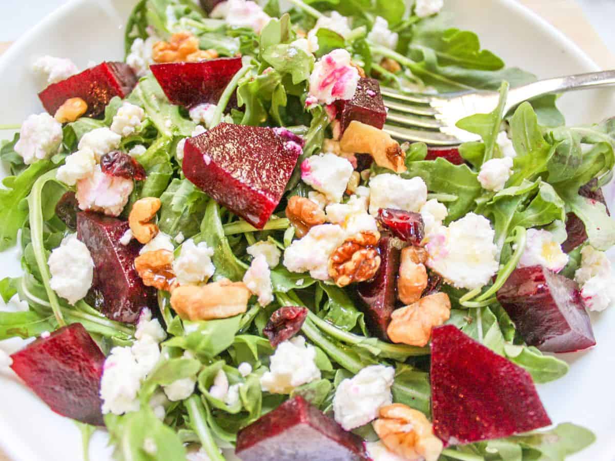 Arugula salad with diced beets. crumbled goat cheese and walnuts. 