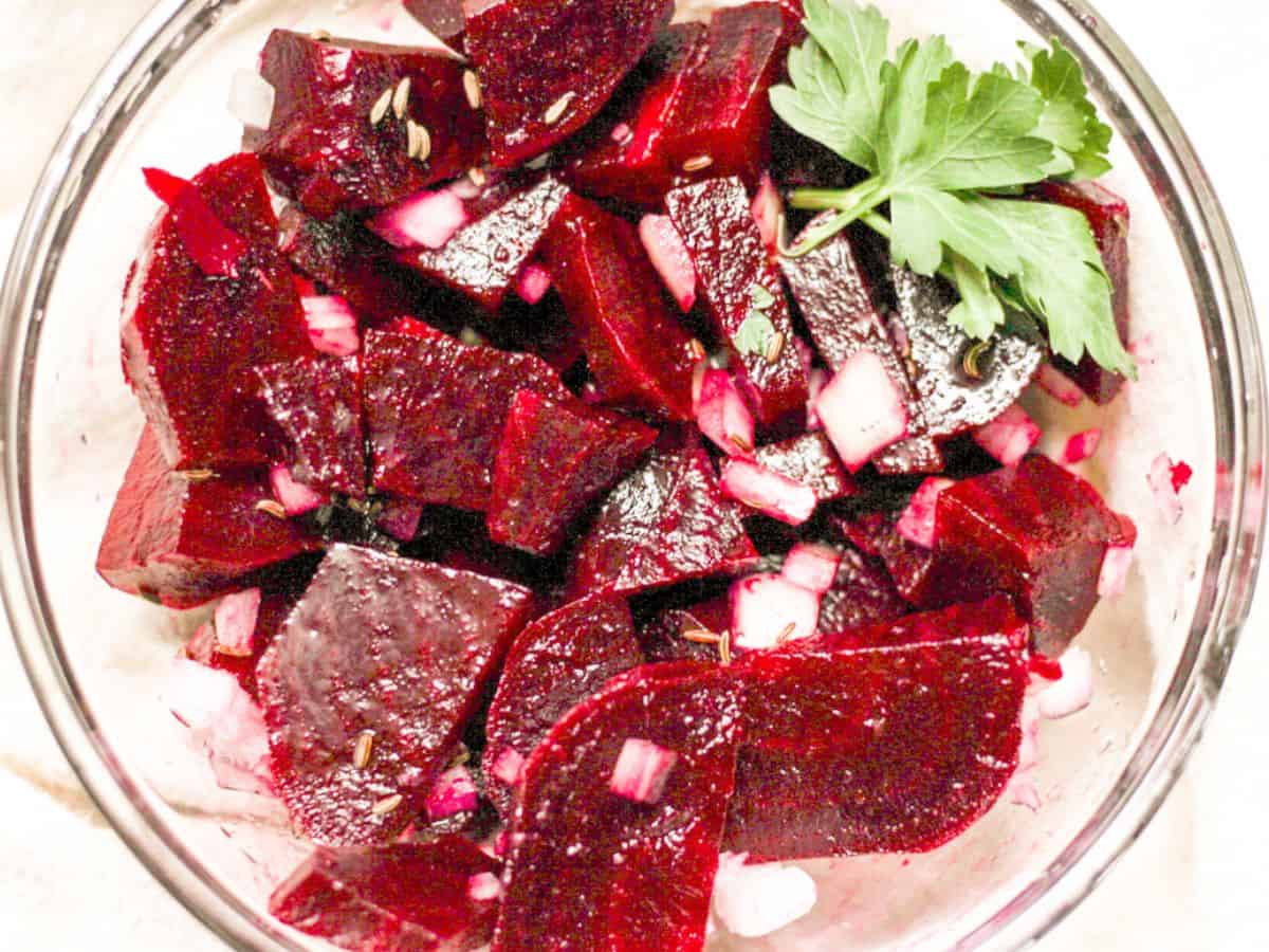 German marinated beet salad with onio0ns and parsley in a bowl 