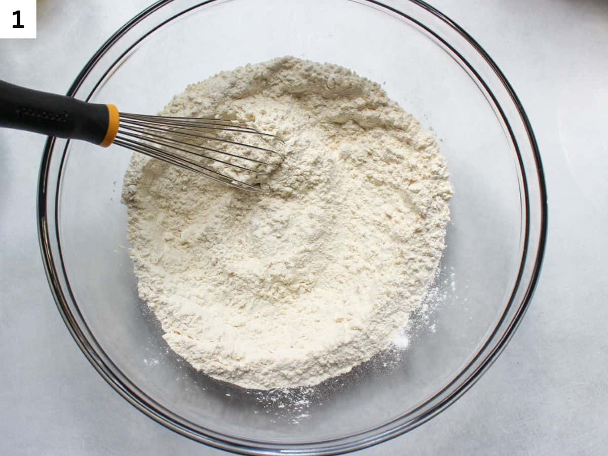 Whisking flour, baking powder, baking soda and salt in a glass bowl. 
