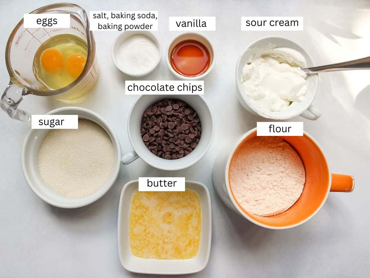Sour cream chocolate chip muffins ingredients on a white background.  