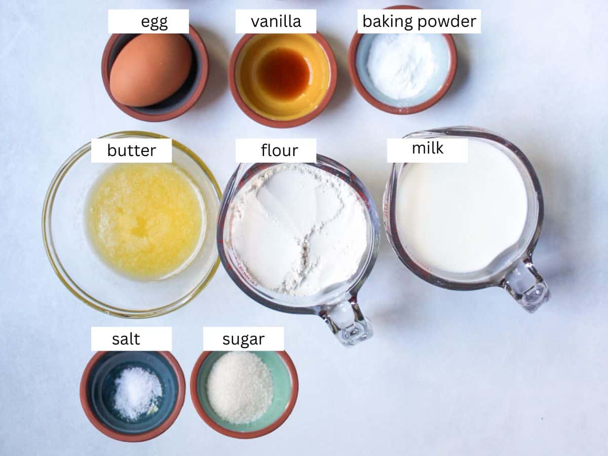 Recipe ingredients on a white background for making fluffy pancakes.