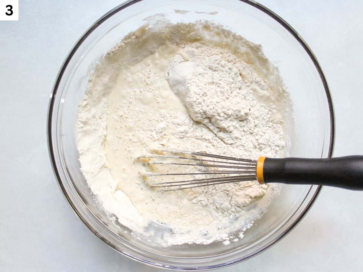 Adding wet ingredients to dry ingredients.