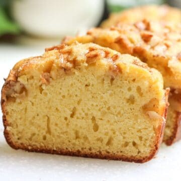 A fresh slice of homemade apple bread packed with apples.