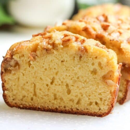 A fresh slice of homemade apple bread packed with apples.