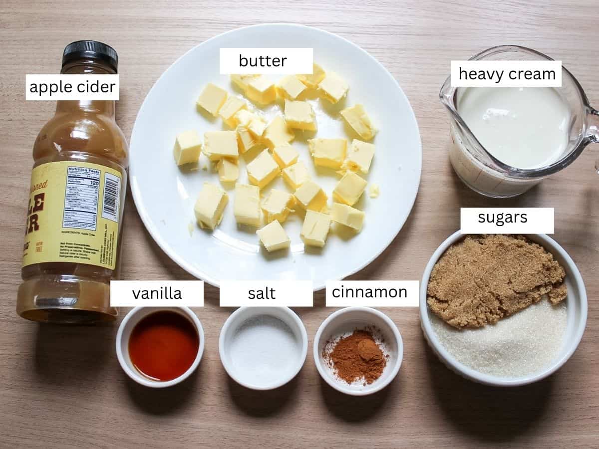 Apple cider caramel sauce recipe ingredients on a wooden surface. 