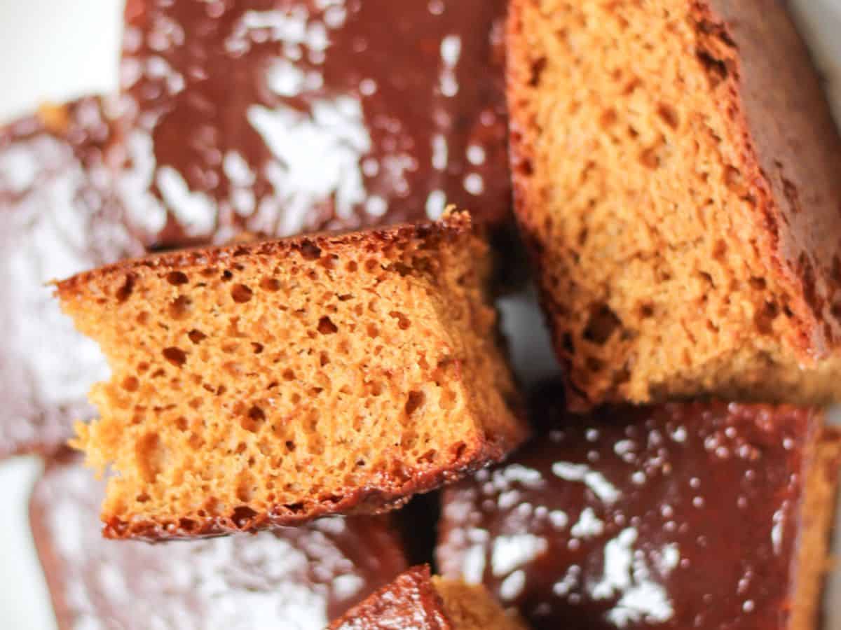 Slices of one layer honey cake piled up on a plate.
